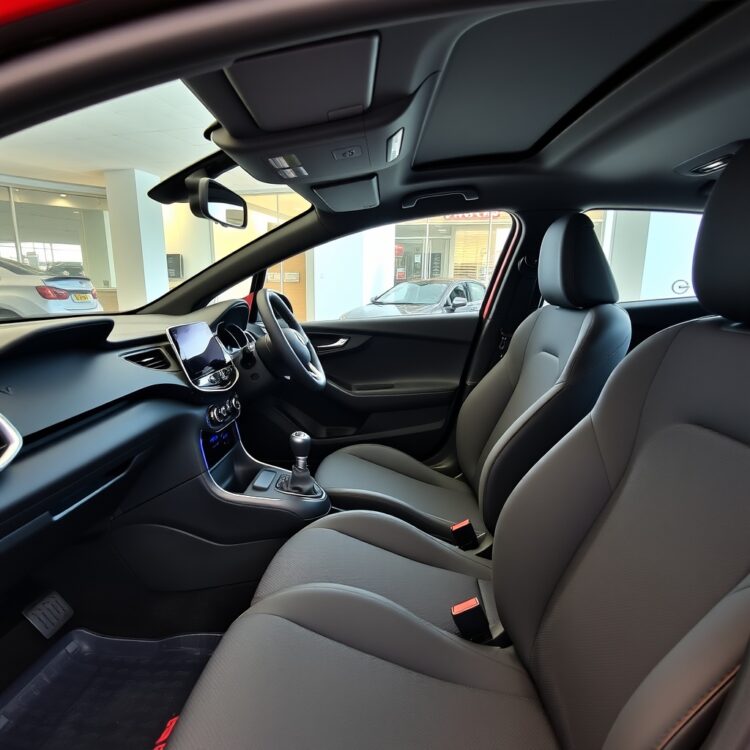 The interior of a Vauxhall Corsa VXR, highlighting the modern dashboard, infotainment system, and comfortable seating in a well-lit showroom setting.