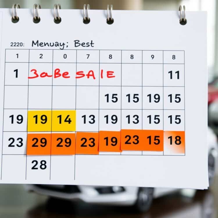 A professional stock photo of a calendar with car sale trends highlighted, symbolizing the best time to sell a vehicle, with a Ford Fiesta subtly in the background.