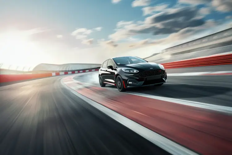 A sporty Ford Fiesta racing on a track, representing the fastest Fiesta models and their top speed capabilities.