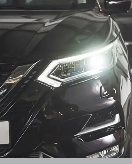 a black car with headlights on